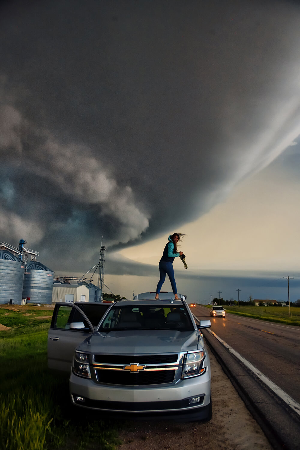 Photographer on top of a car shooting the tornado
