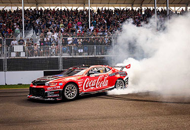 Image of a racecar in action with lots of smoke