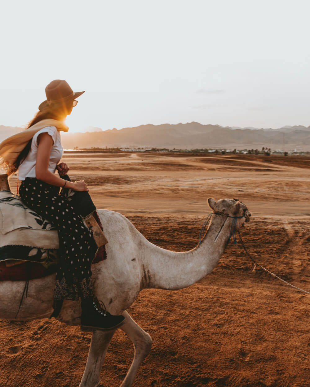 photo of a girl riding a camel. Shot by Jona Grey