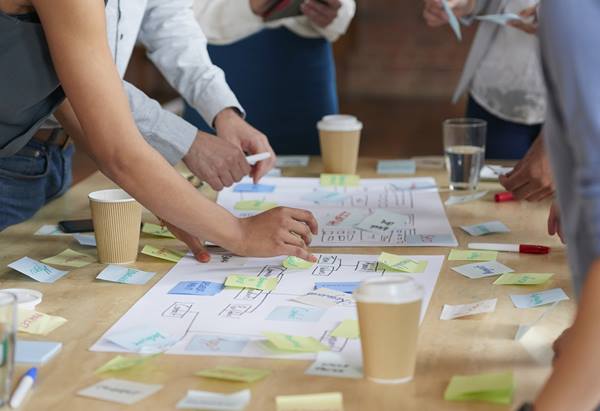 people planning with post it notes on a desk