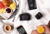 Flatlay image of camera gear and breakfast in bed taken using Canon EOS R50