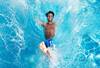 Man splashing on a pool