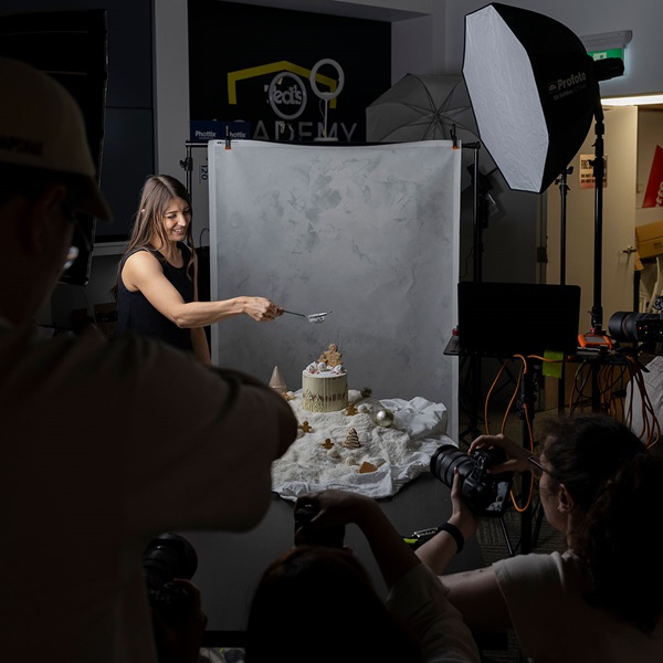 Image of a cake pictorial event being photographed by other photographers