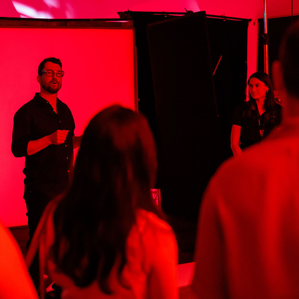 Image of a speaker in front of his audience