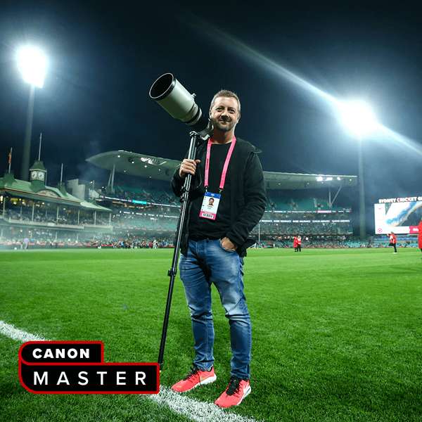 Image of Canon Master Phil Hillyard holding a Canon EOS camera with a telephoto lens