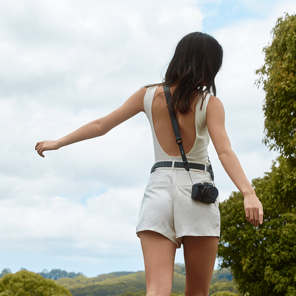 Model carrying the Canon EOS R50 with the Status Anxiety leather strap photographed by Leni Ali Studios