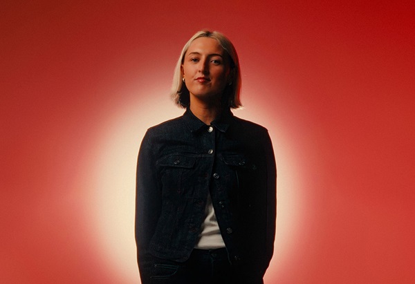 Image of The Circle mentor Darcy Goss in a studio with red background