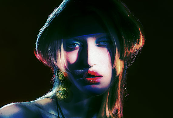 Creative shot of a fashion model in colourful makeup and eclectic haircut