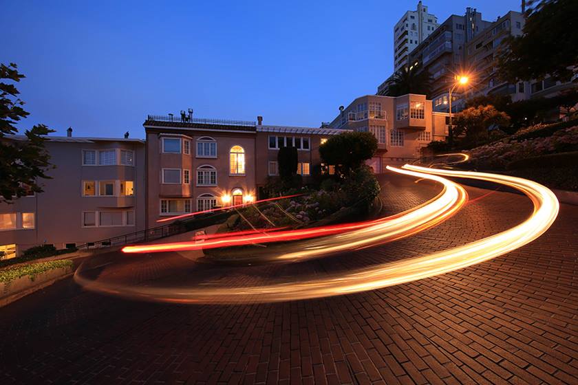Image of a light trail left by a car on a winding road at night taken with the Canon EF 11-24mm f4L USM wide zoom lens