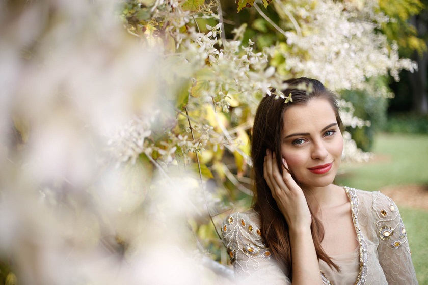 Image of model among flowers taken using EF 50mm f/1.8 STM
