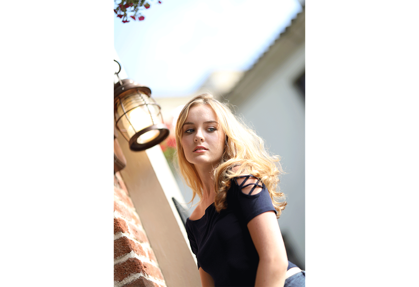 Portrait image of blonde woman near light