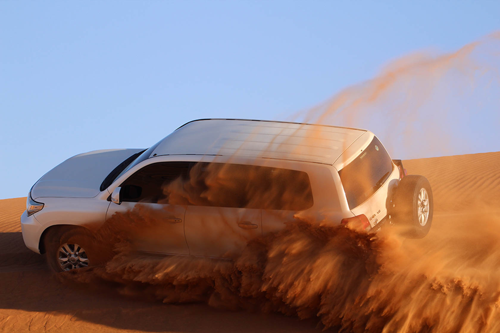 White 4X4 driving through sand dunes taken with Canon EOS 1300D DSLR camera