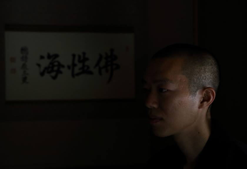 Portrait of a Japanese monk in low light, taken with the EOS R