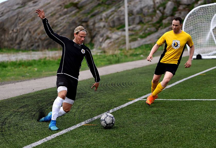 Image of football players about to kick the ball