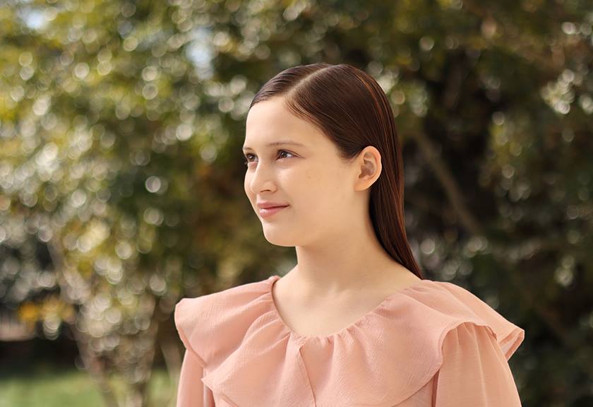 Portrait image of girl wearing a ruffly dress