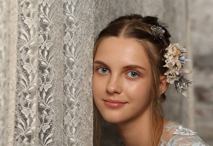 Portrait image of a model with flowers on hair taken using the EOS R6 Mark II mirrorless camera