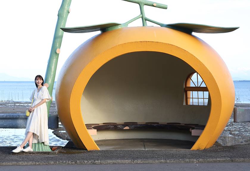 Model posing next to the melon house taken using EOS R8