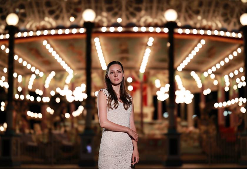 Model in front of carousel taken using RF 85mm f/1.2L USM DS prime lens