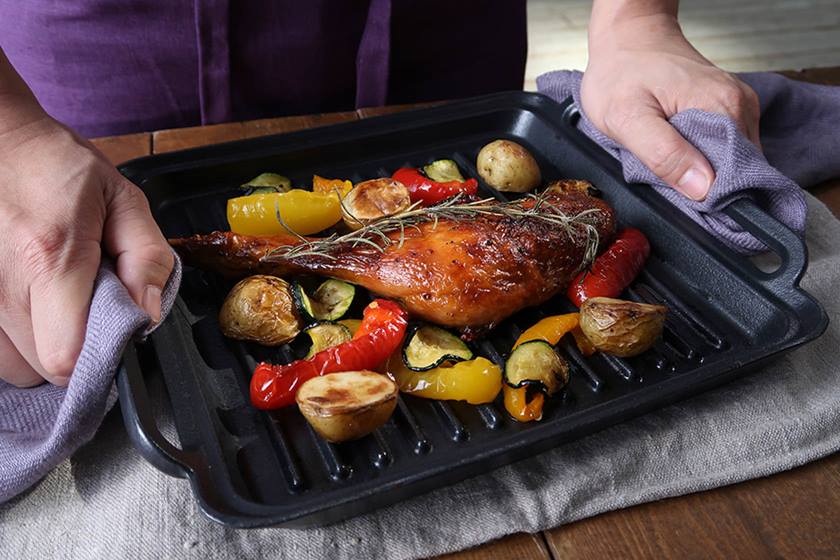 Photo of a man holding roast duck and vegetables shot on PowerShot G7X Mark II