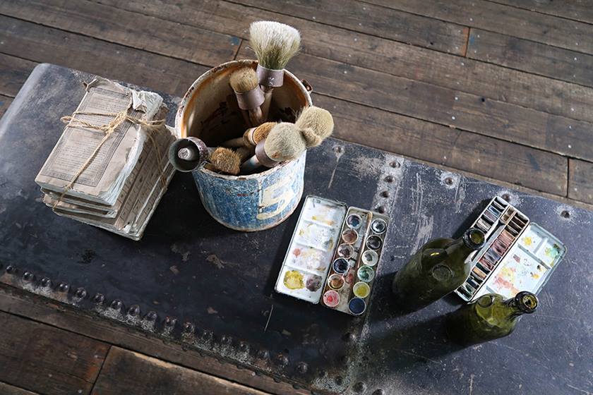 Photo of paint brushes on a table shot on PowerShot G7X Mark II