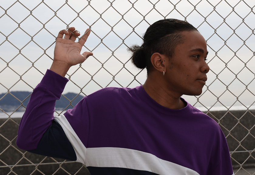 Image of model posing on a chain link fence taken using RF-S 18-45mm f/4.5-6.3 IS STM standard zoom lens