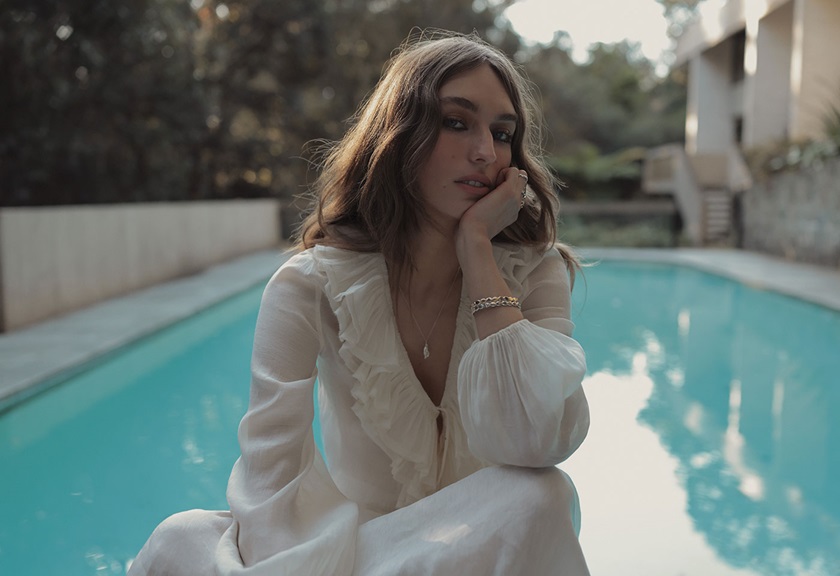 Image of a woman posing sitting near a pool taken by Steven Chee