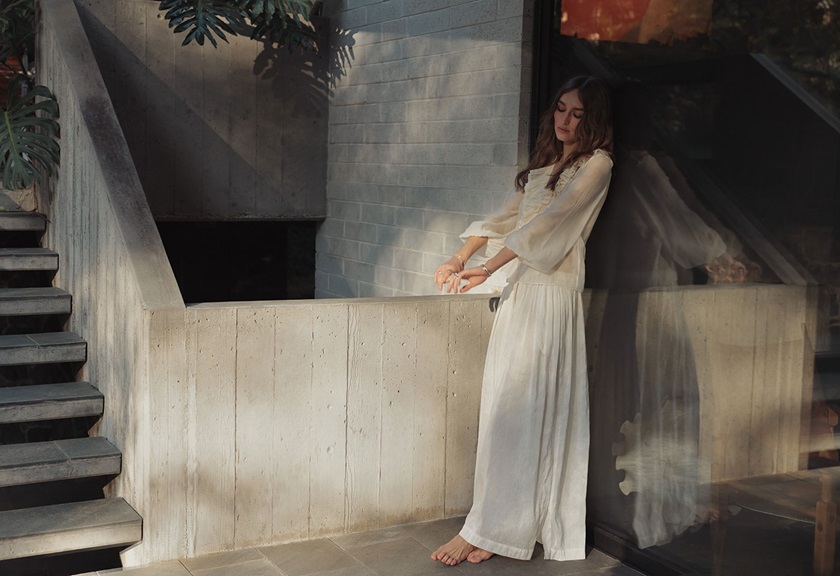 Image of a woman in a white dress posing near the stairs taken by Steven Chee