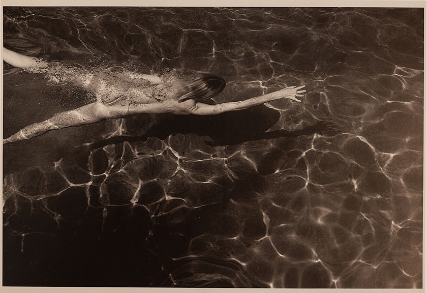 Fashion photography image of a woman swimming on a pool by Steph Pedersen