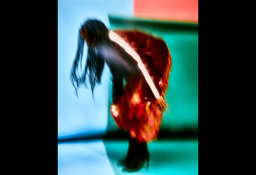 Fashion photography image of a woman wearing orange pants and black boots by MACAMI