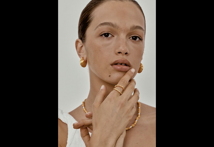 Fashion photography image of a woman showing her gold jewelry by Steph Pedersen