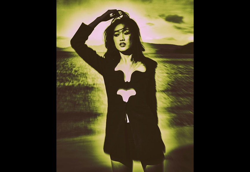 Fashion photography image of a woman wearing all black in yellow lighting by MACAMI