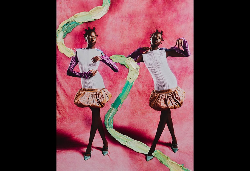Fashion photography image of two women in identical outfits on a pink background by MACAMI