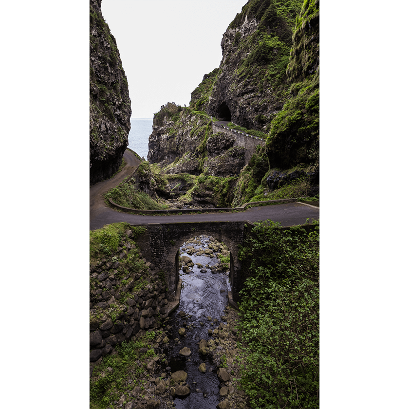 Image of a small bridge across lush green landscape and gorge