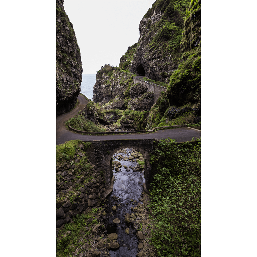 Image of a small bridge across lush green landscape and gorge