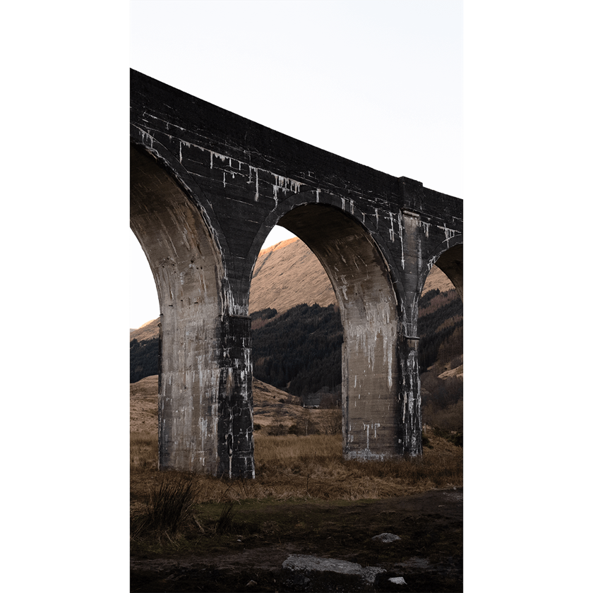 Image of arches of Glenfinnan bridge in Scotland at dusk