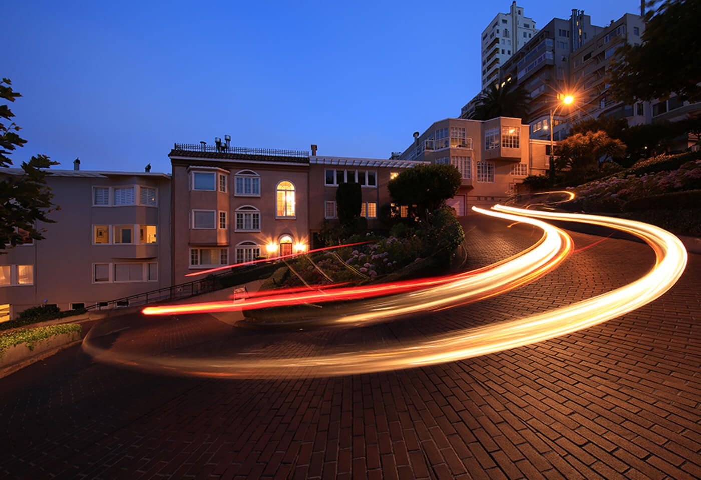 Image of a light trail left by a car on a winding road at night taken with the Canon EF 11-24mm f4L USM wide zoom lens