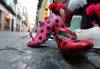 Pink and black polka dot shoes on street