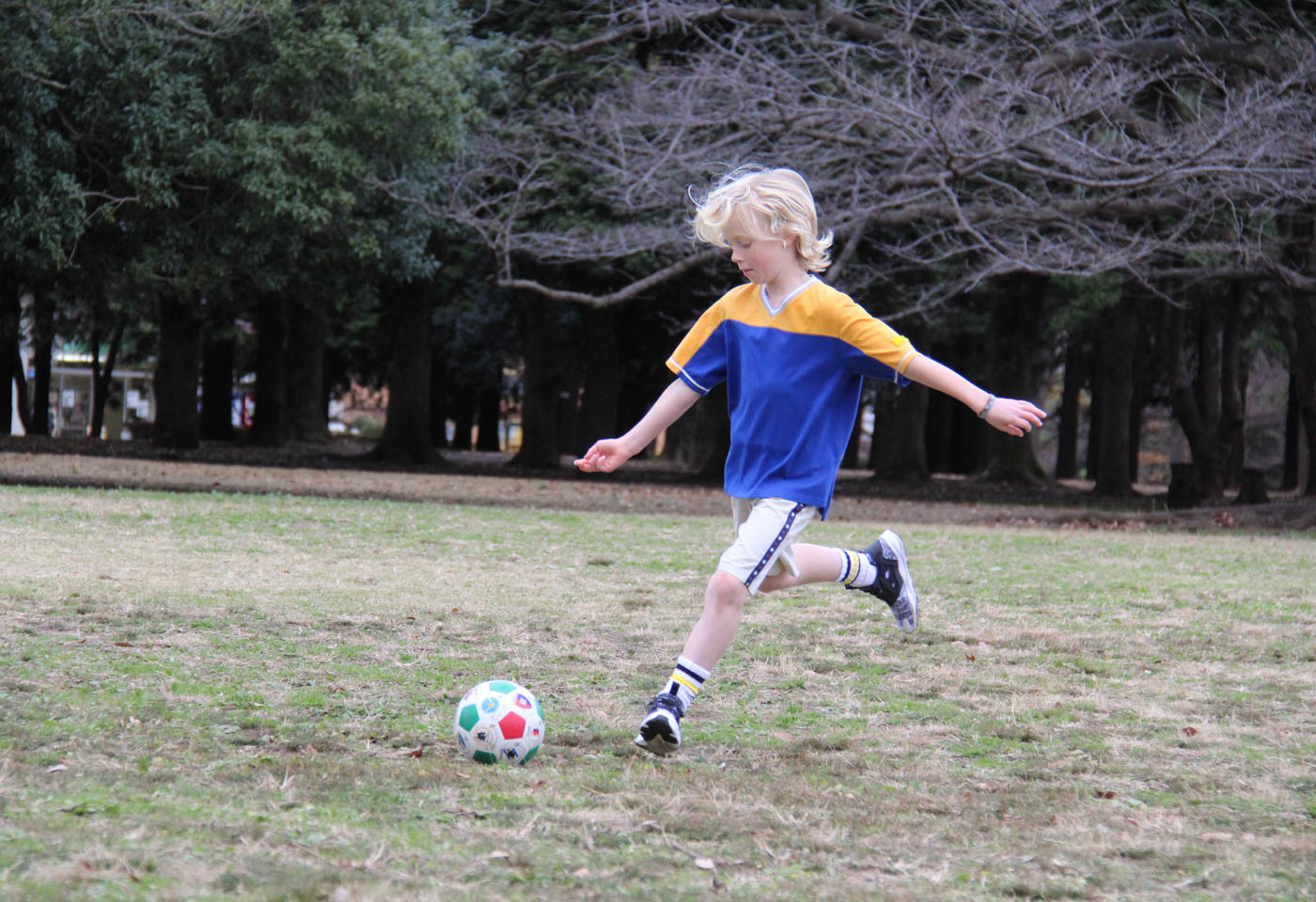 Kid playing soccer taken with Canon EOS 1300D DSLR camera
