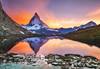 mountain ranges at sunset with orange and purple skies