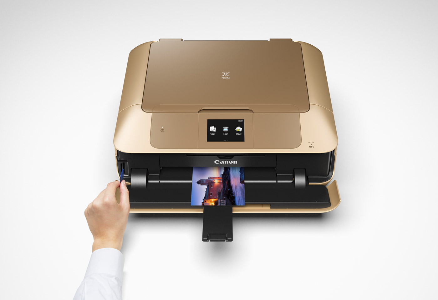 gold printer with hand putting in an SD card