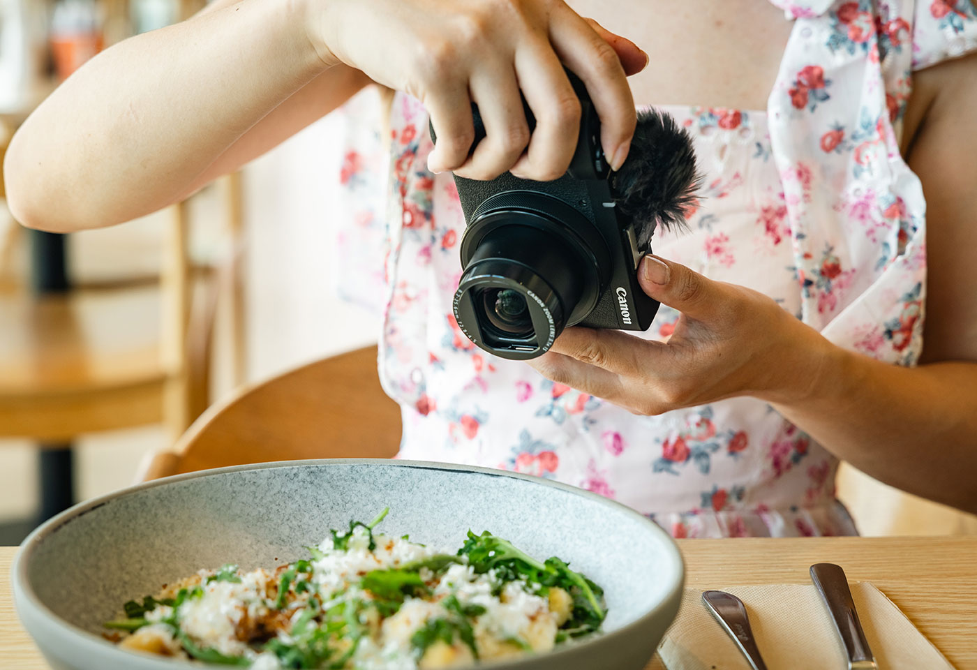 Image of the PowerShot V1 mounted on a tripod used by a content creator