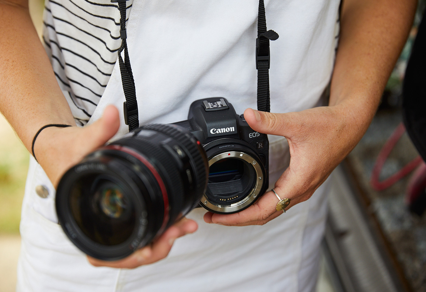 Person holding Canon EOS R with Drop-in Filter Mount Adapter EF-EOS R and lens