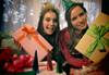 Image of two girls holding wrapped presents