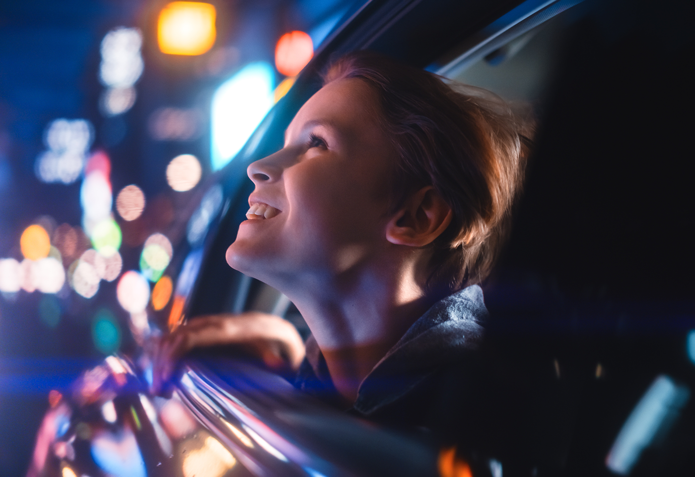 Image of woman in a car with bokeh background taken using the CN-E 31.5-95mm T1.7 Cinema lens