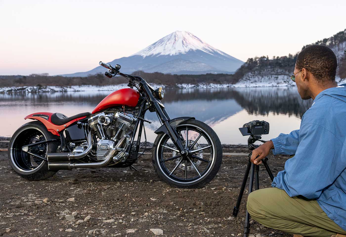 Motorcycle being photographed in front of a snowy mountain
