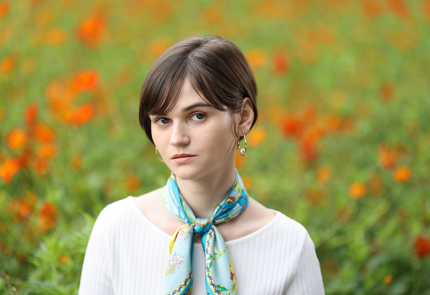 Portrait image of a model in a flower field taken using the RF 135mm f/1.8L IS USM prime lens