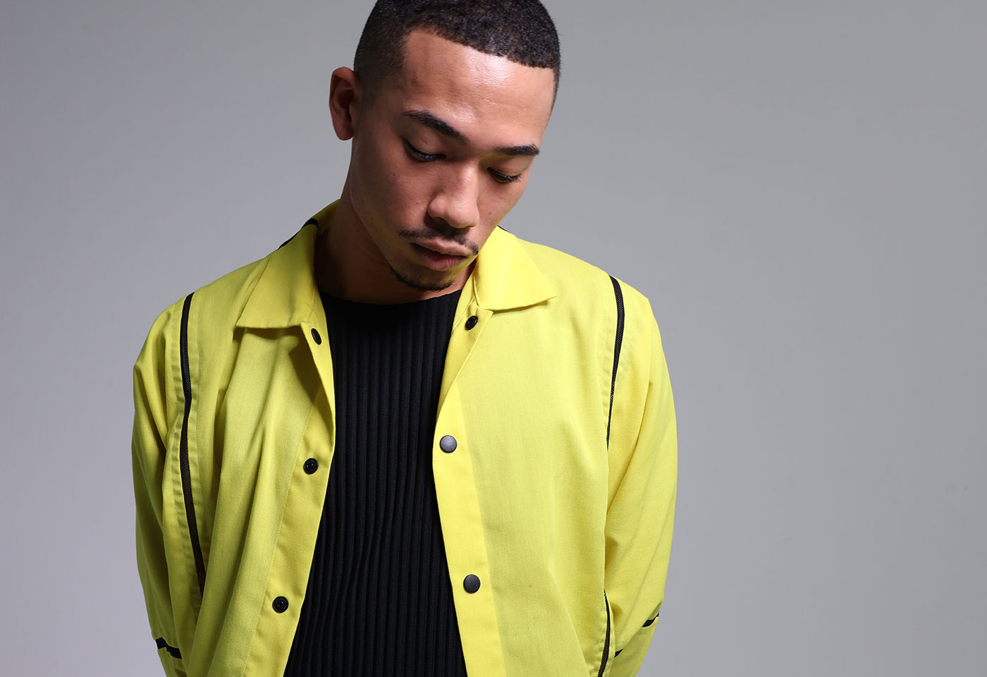 Image of a man wearing a yellow top