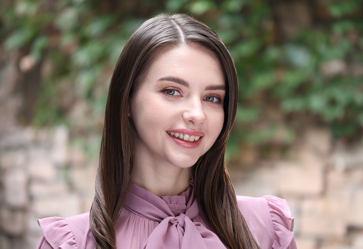 Portrait image of model smiling taken with the RF-S 55-210mm f/5-7.1 IS STM telephoto lens