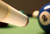 Image of cue stick about to hit a pool ball