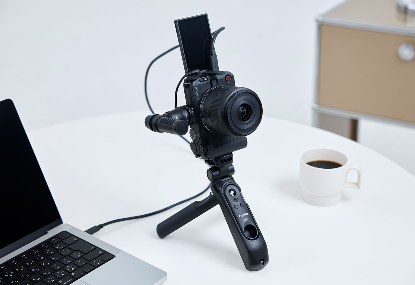 Image of the EOS R50 V mirrorless camera mounted on a tripod